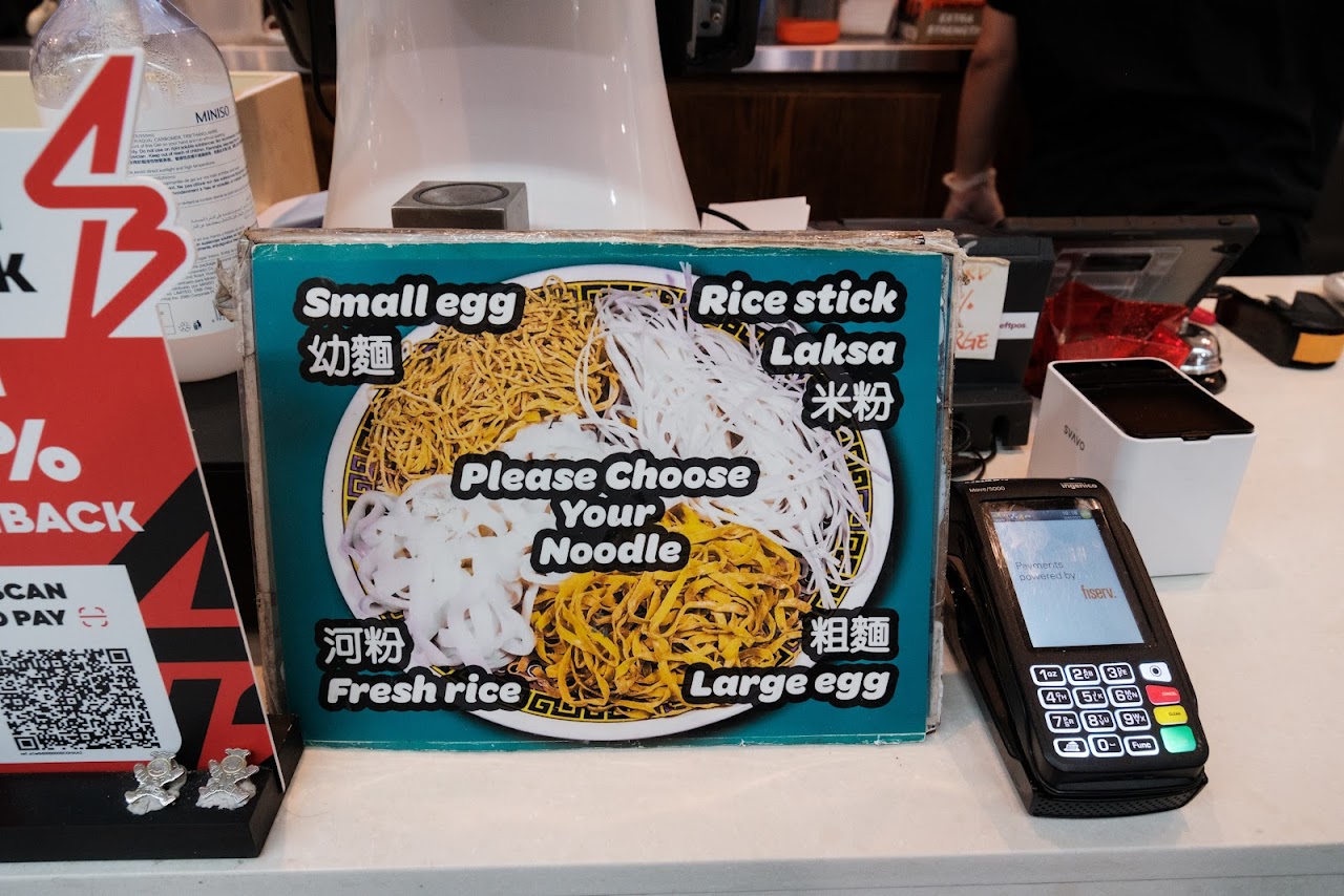 Noodle-choice counter sign beside the payment terminal